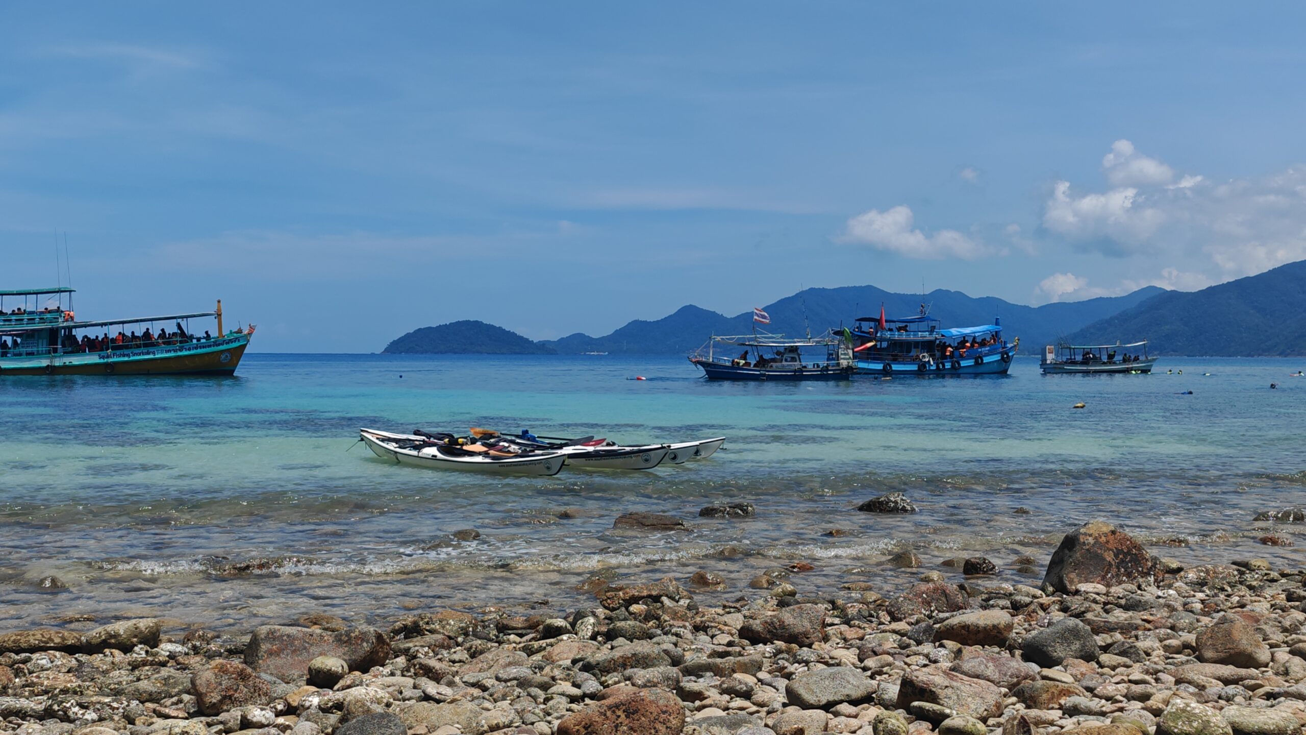 Sea kayakers paddling between islands during a three-day expedition in Koh Chang, Thailand